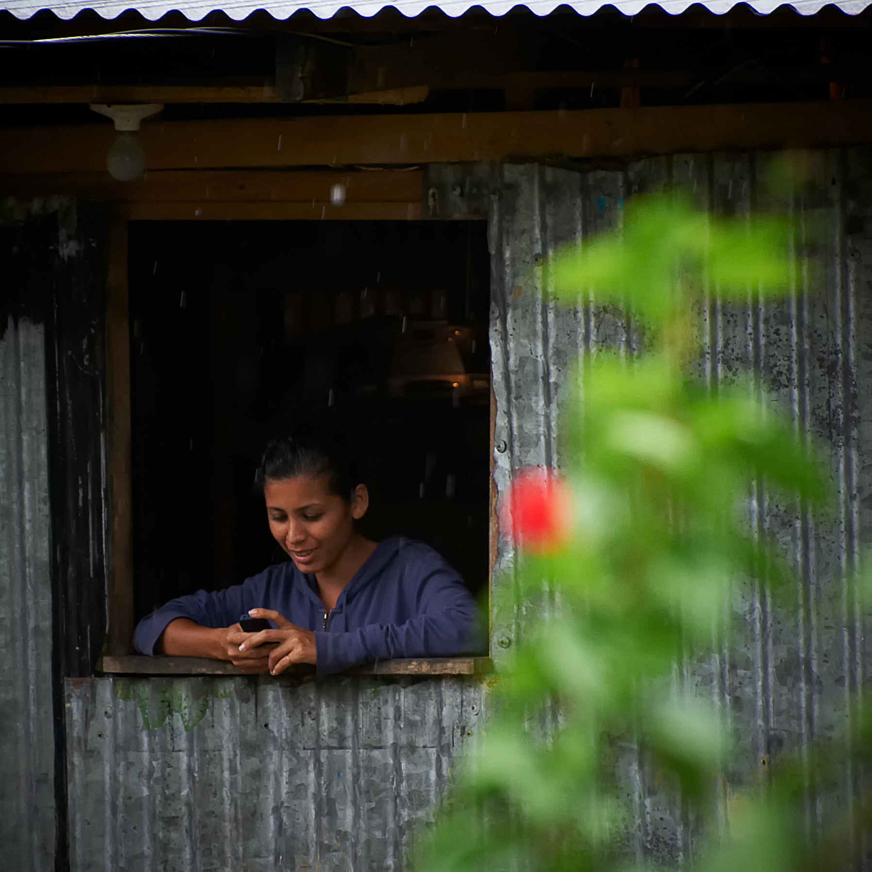 Woman Texting from a Rainforest Shack (10-May-2011).